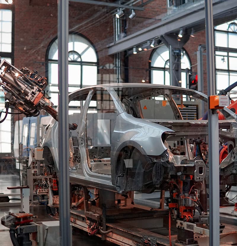 A car body in white on a robotic assembly line.