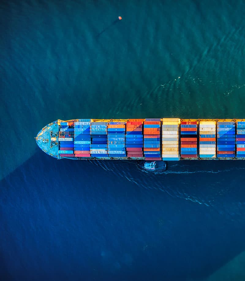 A container ship under way at sea, seen from directly above.